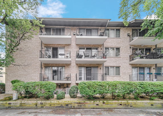 Front view of a multi-story residential building with balconies.