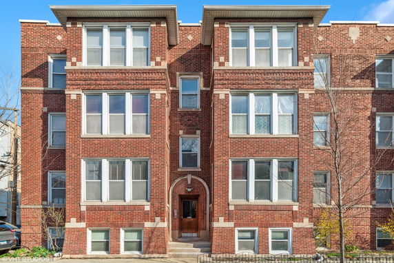 Front view of a multi-story brick building.