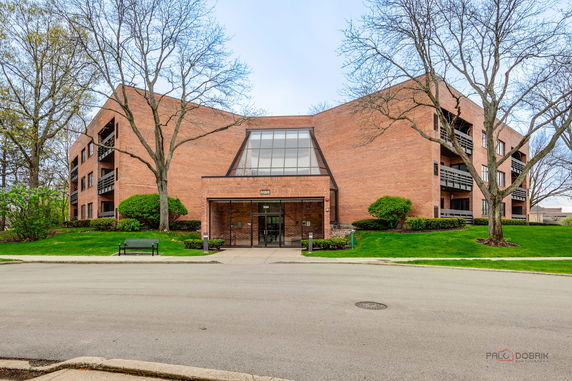 Front view of a multi-story brick building with balconies.