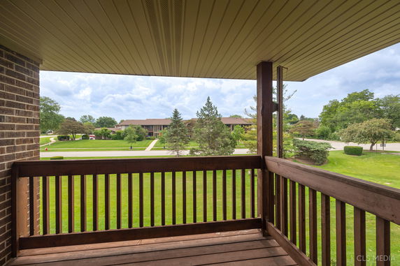 View of surrounding residential area from a covered balcony.