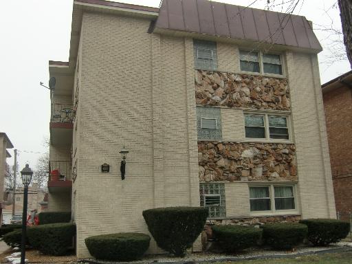Front view of a multi-story building with a stone facade.
