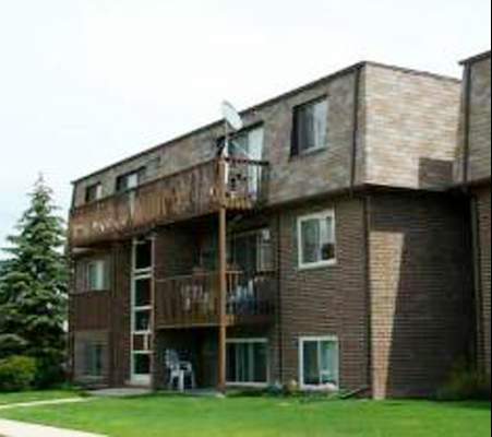 Front view of a multi-story residential building with balconies.
