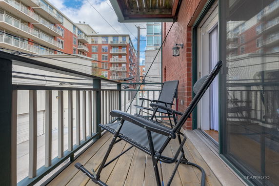View from a balcony overlooking neighboring apartment buildings.