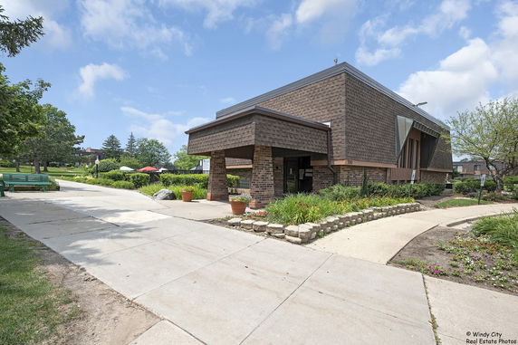 Front view of a building with brick and shingle exterior.