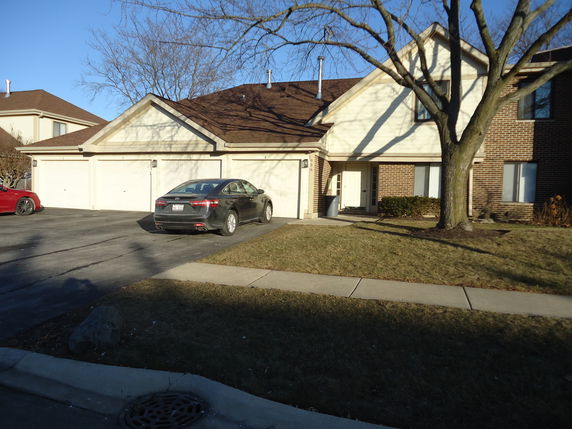 Front view of a multi-story house with attached garage.