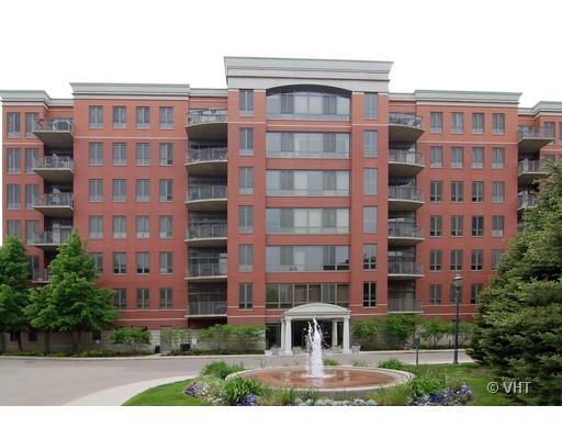 Front view of a multi-story brick apartment building with balconies.