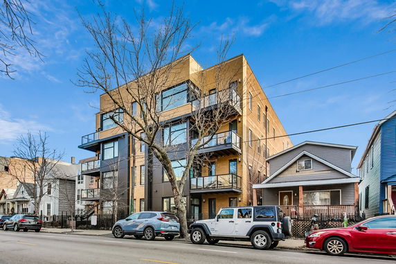 Front view of a modern multi-story apartment building.