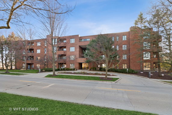 Front view of a multi-story brick apartment building.