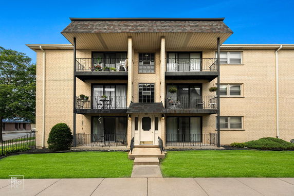 Front view of a multi-story building with balconies.