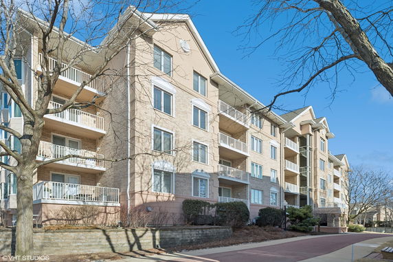 Front view of a multi-story apartment building with balconies.
