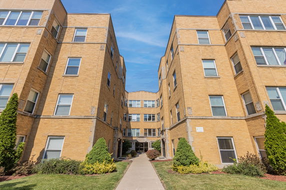 Front view of a multi-story brick apartment building.