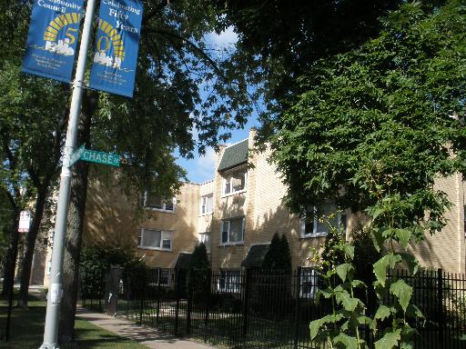 Front view of a multi-story residential building with brick exterior.