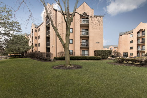 Front view of a multi-story apartment building with balconies.