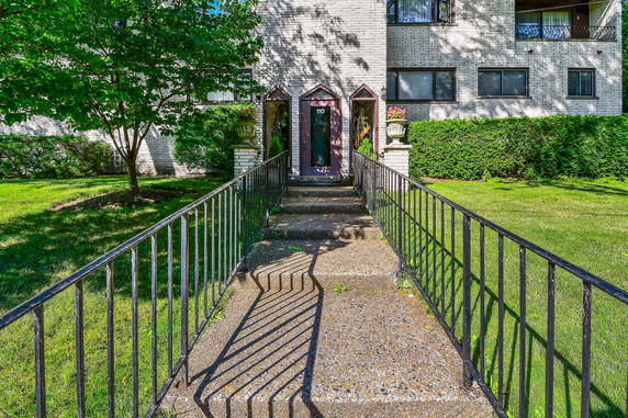 Front view of a building with a walkway leading to the entrance.