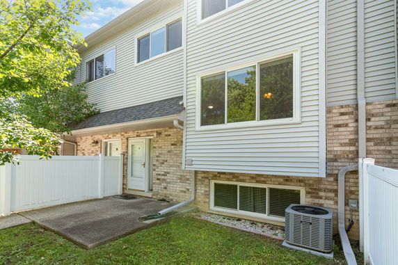 Front view of a two-story house with a brick and siding exterior.