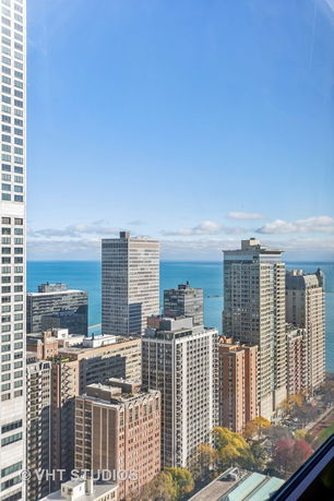 Panoramic view of city buildings with a water body in the background.