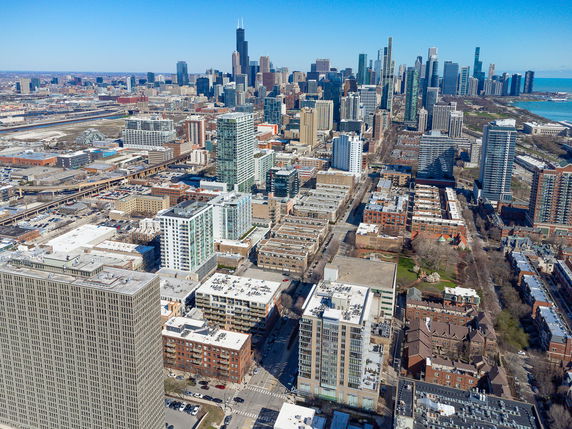 Panoramic view of a cityscape with tall buildings and urban layout.