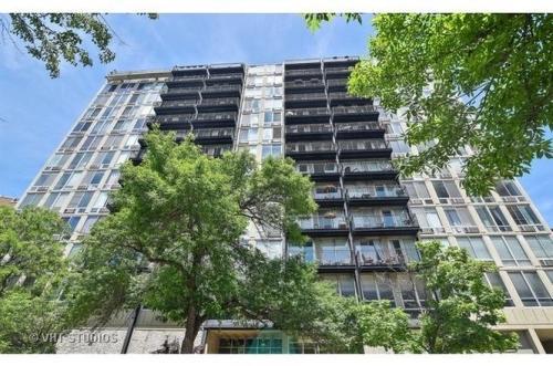 Front view of a multi-story apartment building with balconies.