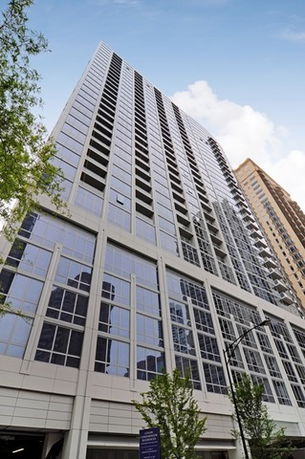 Front view of a high-rise building with a glass facade.
