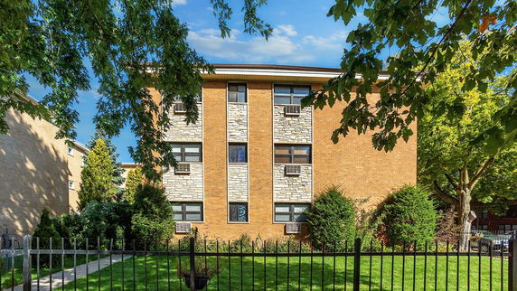 Front view of a three-story brick apartment building.