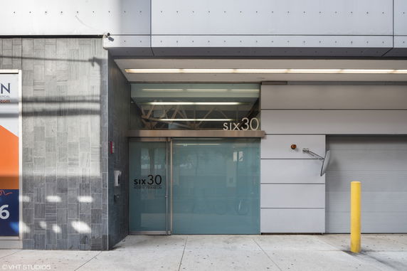 Front view of a modern building entrance with the number 630 displayed.