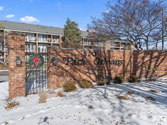 Front view of a multi-story residential building with a brick facade.