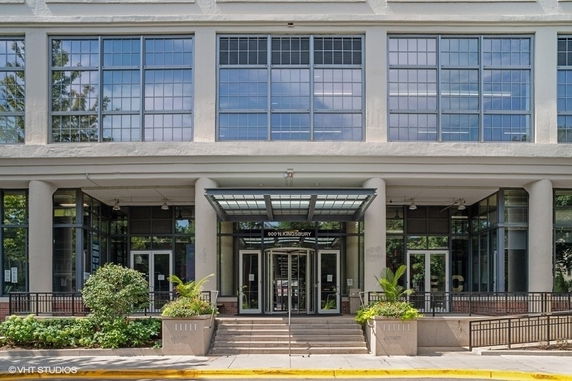 Front view of a commercial building with large glass windows and multiple entrances.