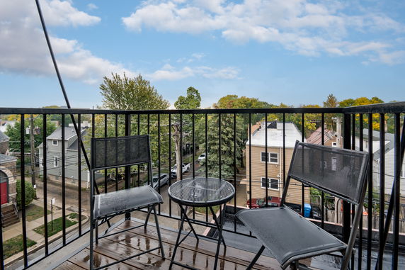 Wide angle view of a neighborhood from a balcony.