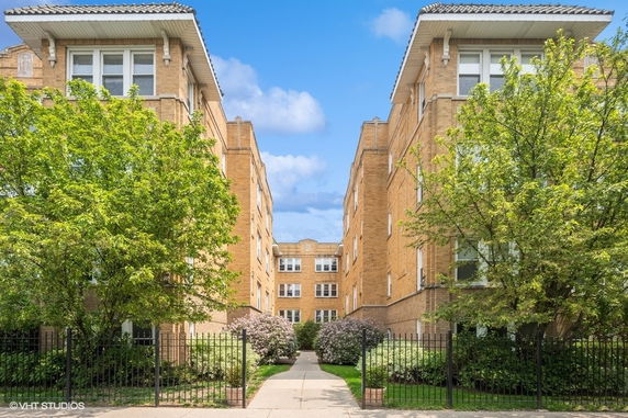 Front view of a multi-story brick apartment building.