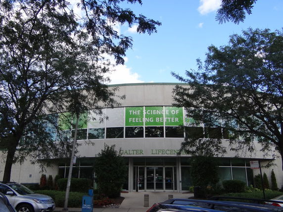 Front view of a two-story building with large windows.