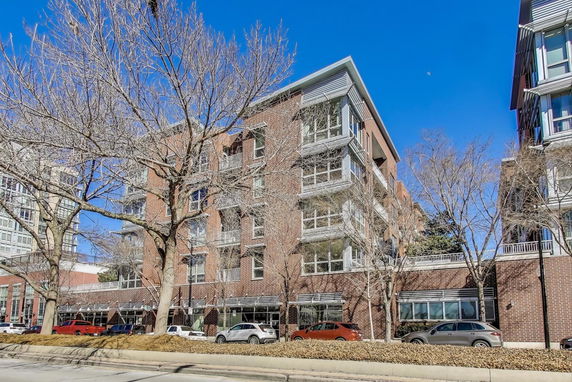 Front view of a multi-story brick building with balconies
