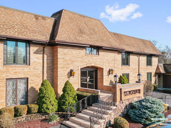 Front view of a two-story brick building with a sloped roof.