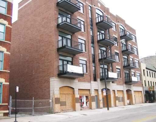 Front view of a multi-story building with balconies.