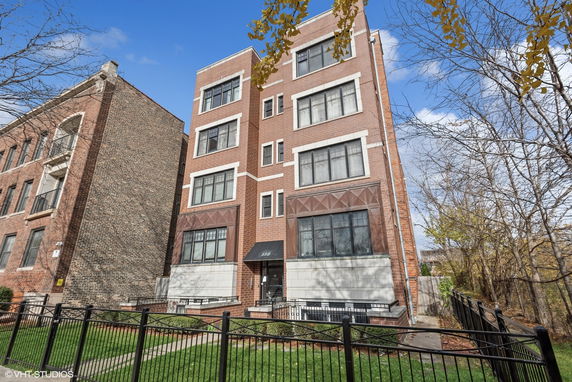 Front view of a four-story brick apartment building.