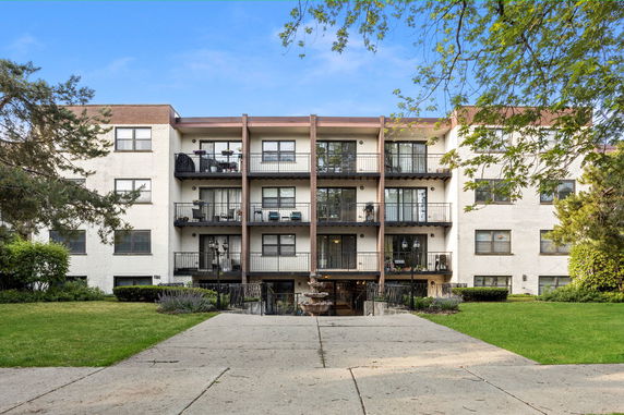 Front view of a multi-story apartment building with balconies.