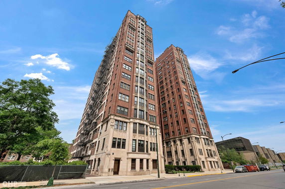 Front view of a multi-story brick building with decorative facade elements.