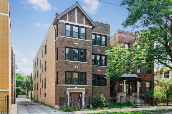 Front view of a three-story brick apartment building.