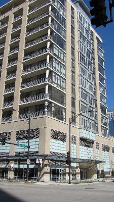 Front view of a multi-story building with large windows and balconies.