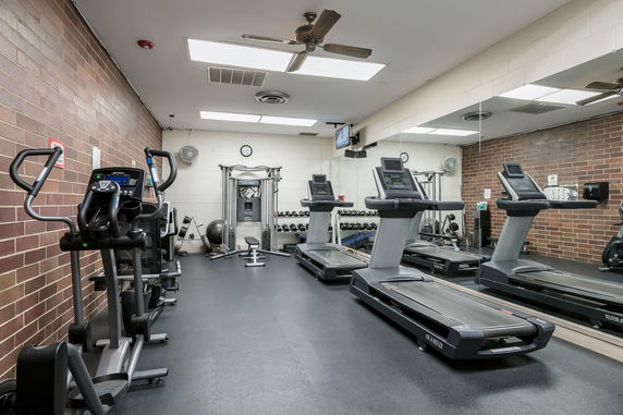 Indoor gym area with treadmills and exercise equipment.