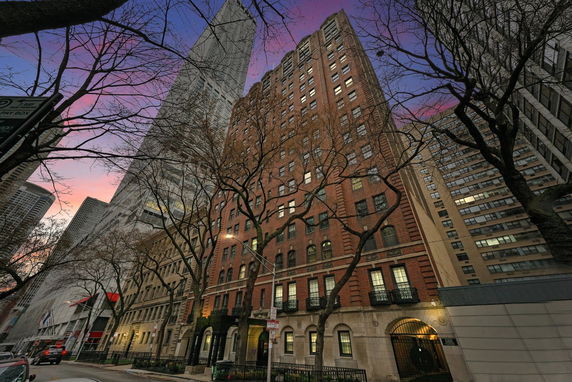 Front view of a multi-story brick building in an urban setting.