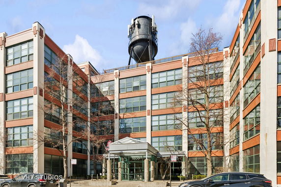 Front view of a multi-story building with a water tower on the roof.
