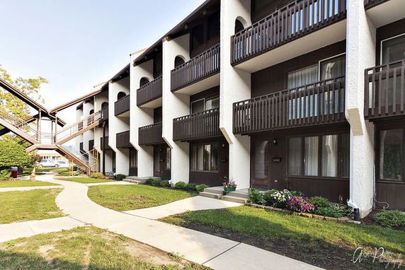 Front view of a multi-story building with balconies.