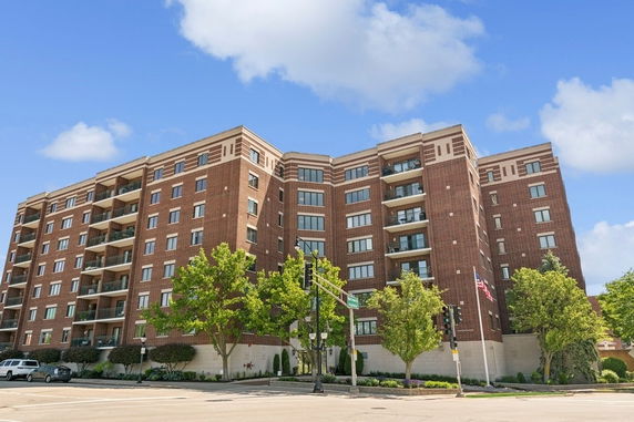 Front view of a multi-story apartment building with balconies.