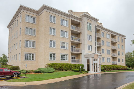 Front view of a multi-story apartment building with balconies.