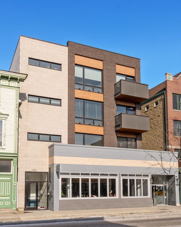 Front view of a multi-story building with balconies.