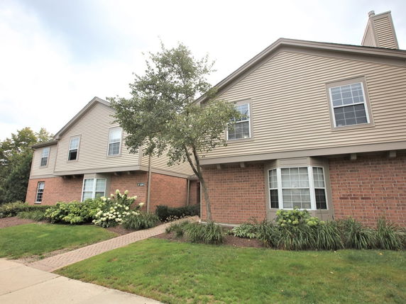 Front view of a two-story house with brick and siding exterior.