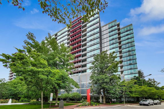 Front view of a multi-story glass building.
