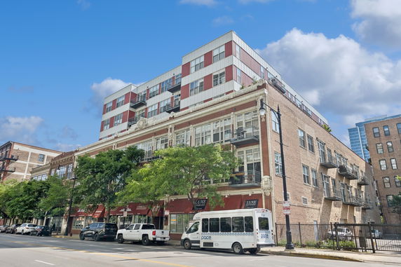 Front view of a multi-story building with modern and classic architectural elements.