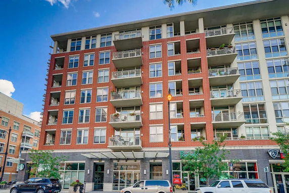 Front view of a multi-story apartment building with balconies.