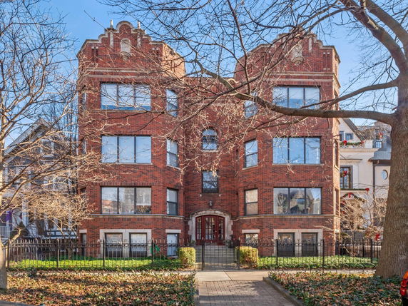 Front view of a brick multi-story residential building.